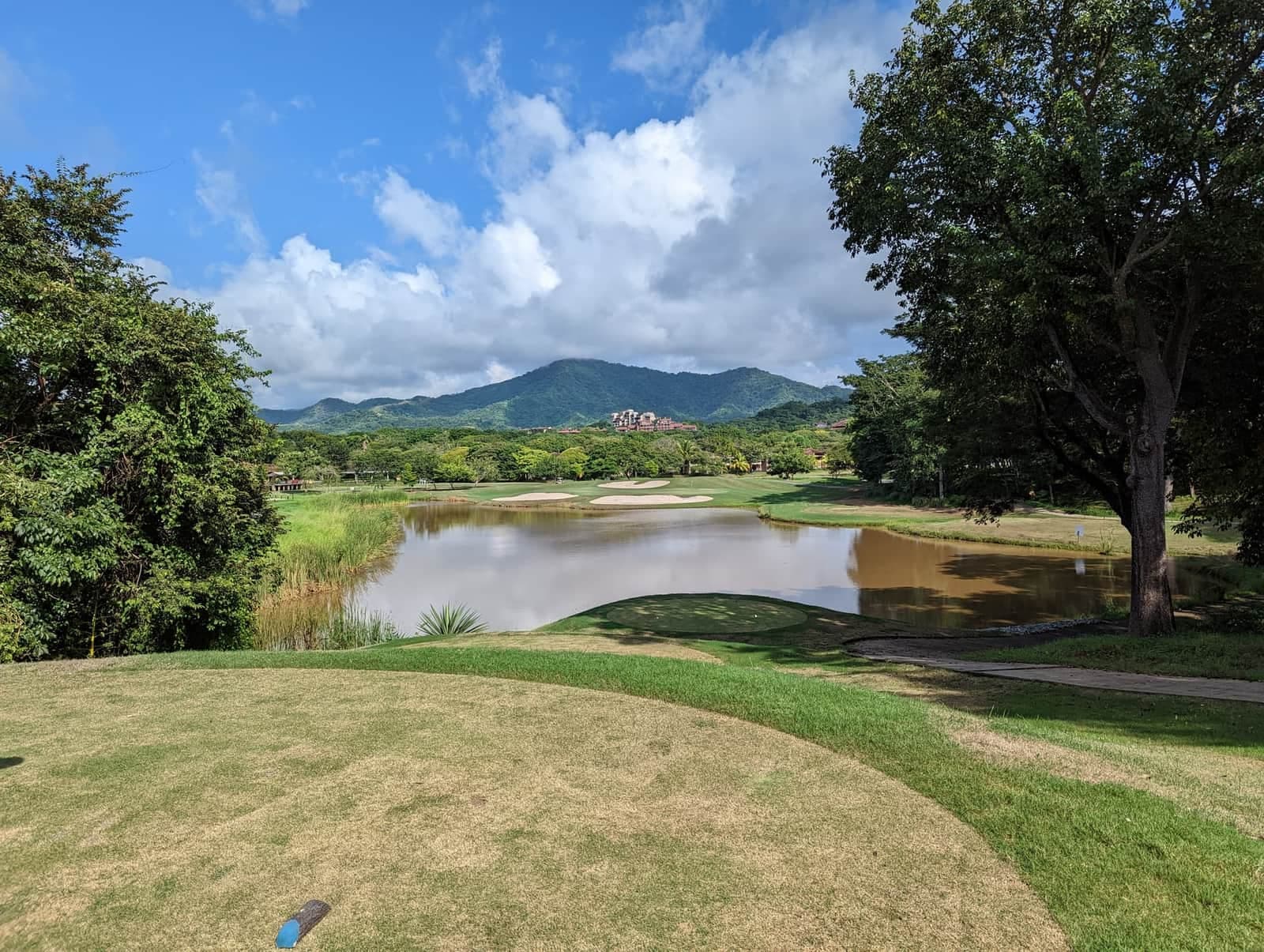 Tropical golf course with lake and mountains