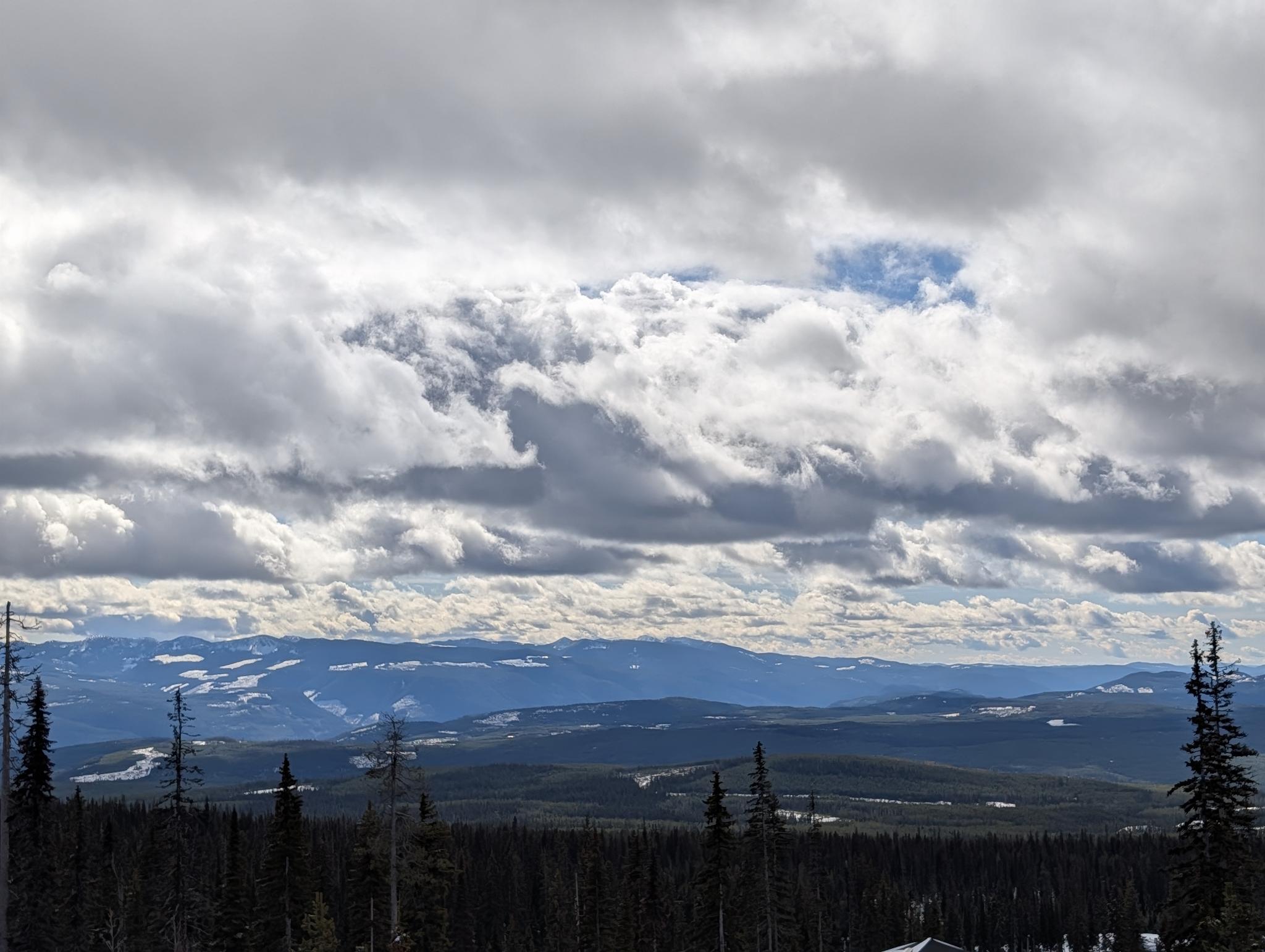 Cumulus clouds over a forested mountain valley, Pacific Northwest